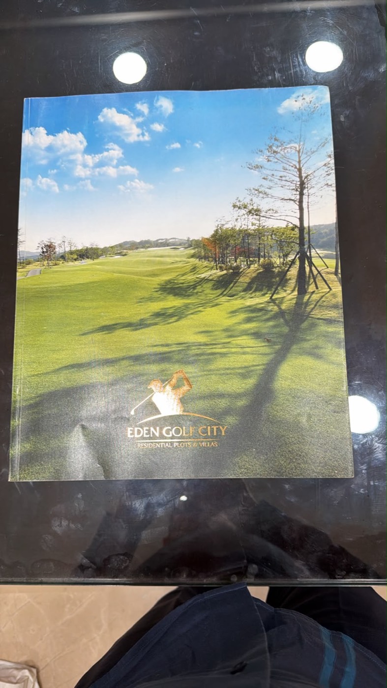 Premium golf township brochure with foil-stamped cover.